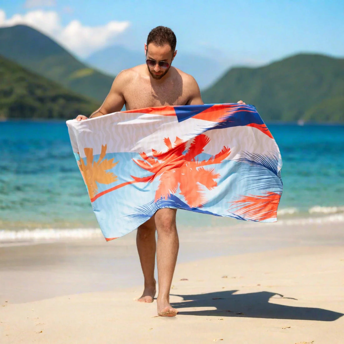 A guy holding a Quick Dry, Sand Free, Light Weight, Compact and Ecofriendly Microfiber Beach Towel from La Toalla