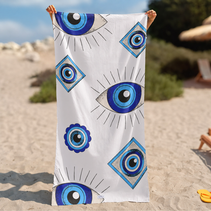 A white beach towel held up by a person&